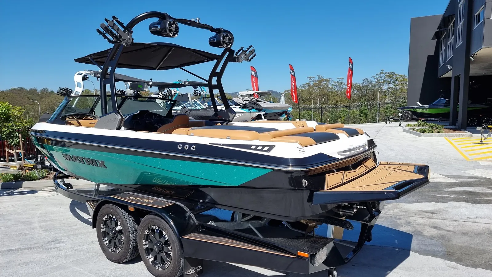 Teal and black MXV from the stern quarter on its trailer